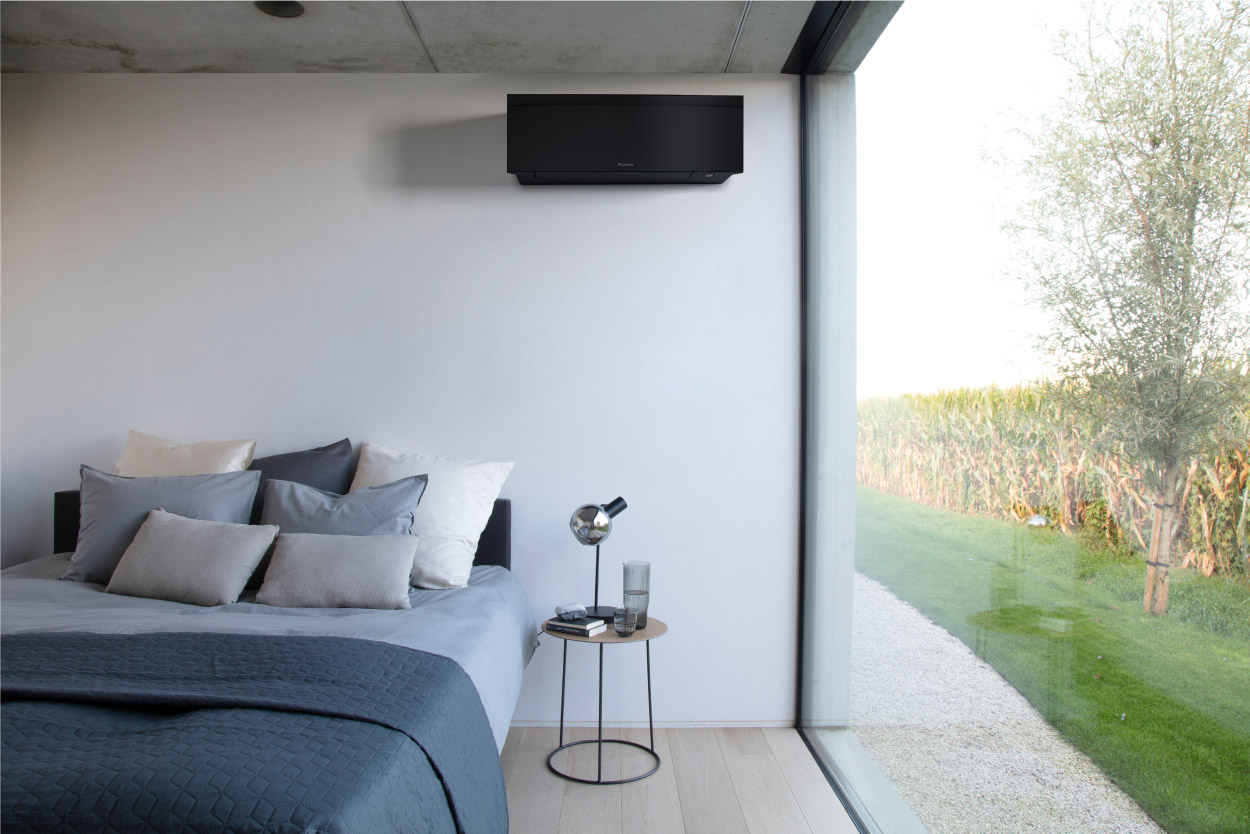 Daikin Stylish black wall-mounted air conditioning unit in a modern bedroom